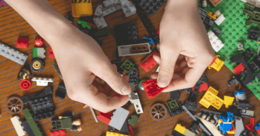 Closeup of child playing with legos