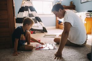 a parent and child playing checkers
