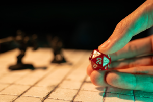 a closeup of a person rolling a dice